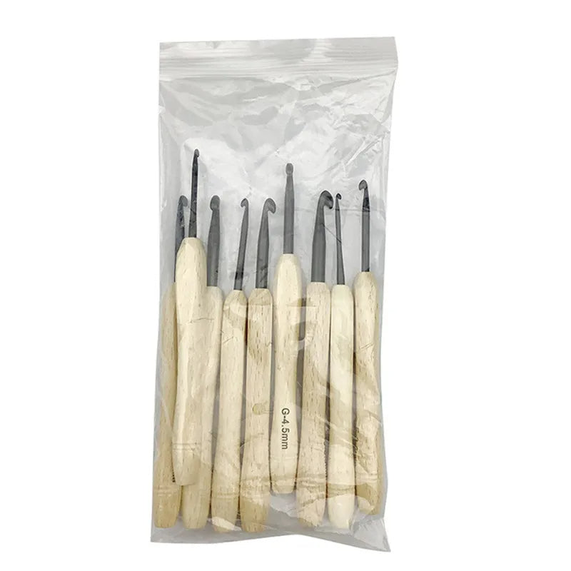 A clear plastic bag contains nine crochet hooks with wooden handles, each featuring an ergonomic grip and a black top clearly labeled with sizes, reflecting exquisite craftsmanship.