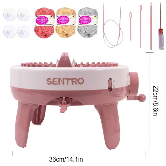 The 40 Needles Knitting Machine Kit comes with yarn balls in vibrant colors, suction cups, and a convenient screwdriver. The charming pink and white machine measures 36cm x 22cm, making it perfect for your creative projects.