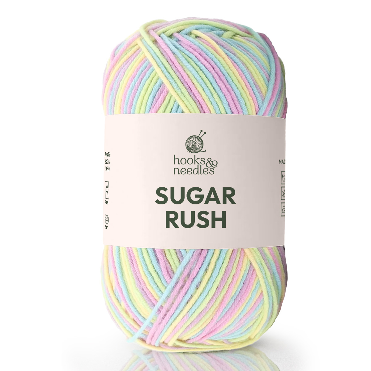 A skein of Sugar Rush Variegated Yarn, a super-fine pastel yarn, featuring knitting needles and a yarn logo on the label.