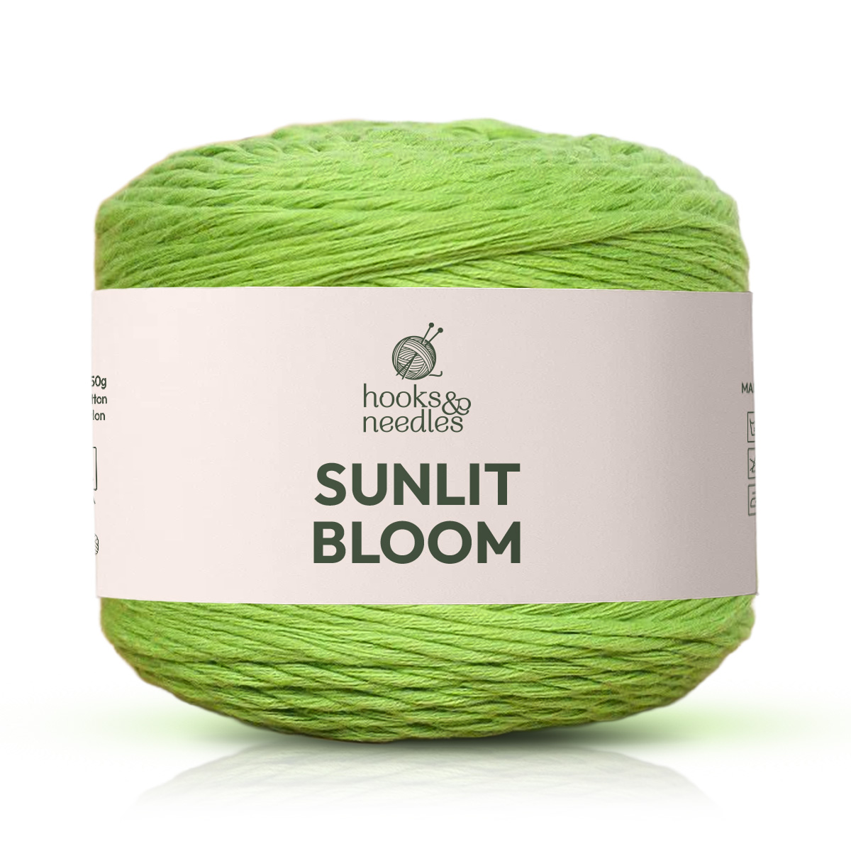 A skein of green, breathable Sunlit Bloom Yarn with a knitting needles icon on the wrapper.