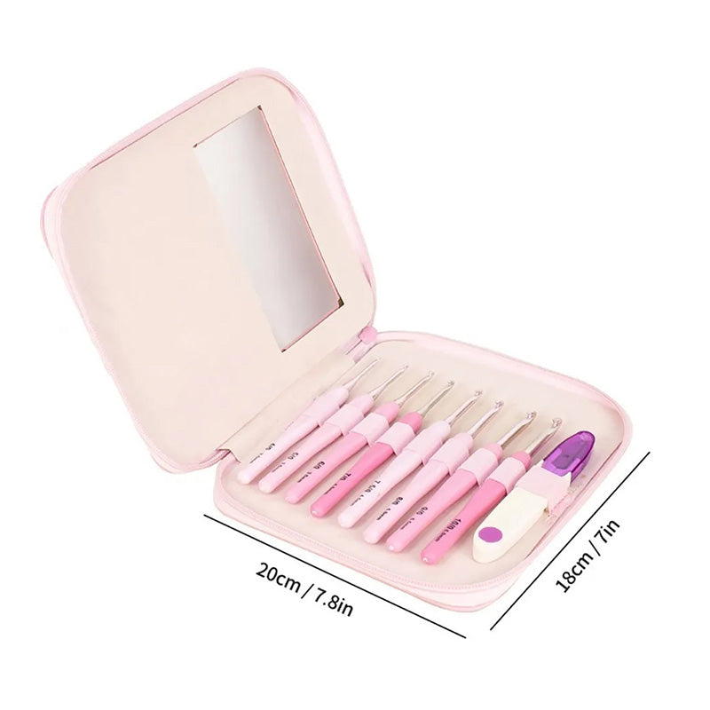 A pink zippered case opens to reveal the Ergonomic Crochet Hook Set 9 Pcs with Case, complete with ergonomic crochet hooks, a measuring tape, and small accessories. The case dimensions are 20cm by 18cm.