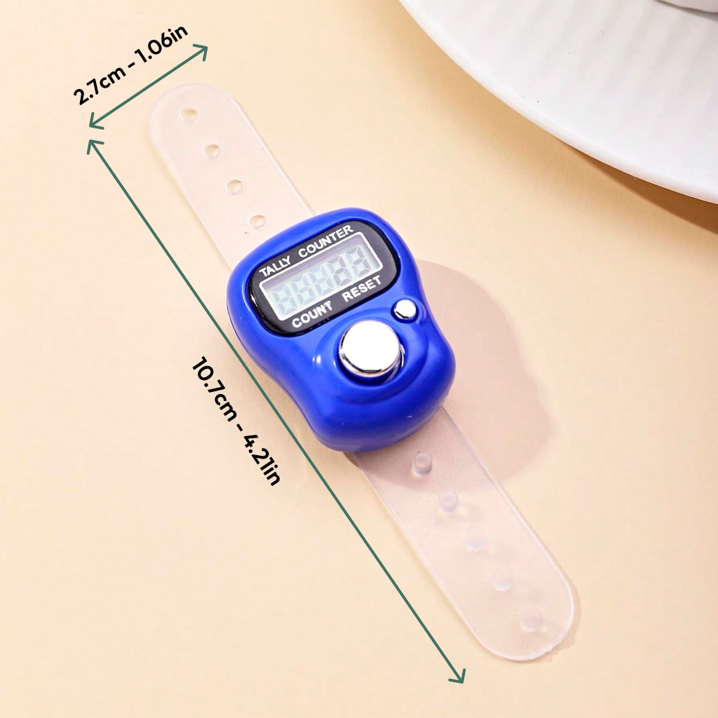 The Digital Row Counter, featuring a blue design and transparent strap (10.7 cm x 2.7 cm), is displayed on a beige surface beside a plate—ideal for easy project tracking.