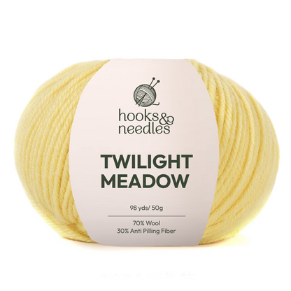A soft, durable light yellow yarn ball labeled "Twilight Meadow Yarn, 98 yds/50g, 70% wool, 30% anti-pilling fiber"—a medium weight wool-blend perfect for cozy projects.