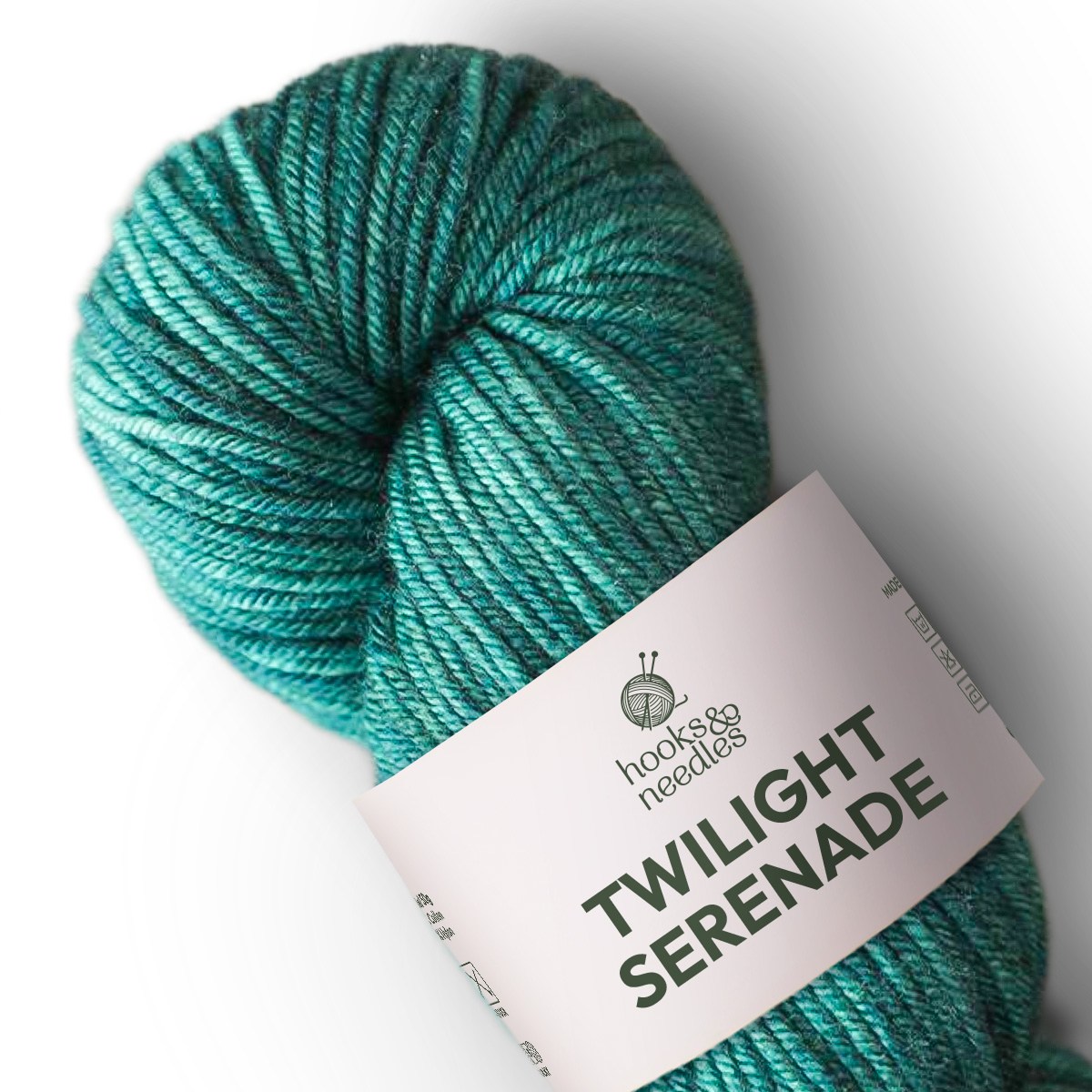 A skein of variegated teal blue, medium weight yarn labeled "Twilight Serenade Variegated Yarn" is displayed on a white background.