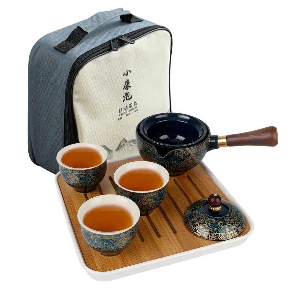 The Tea Making Set With Cups and Case features a portable porcelain tea maker including three ornate cups, a teapot, and a carrying bag on a wooden tray, ideal for tea connoisseurs seeking elegance and functionality.