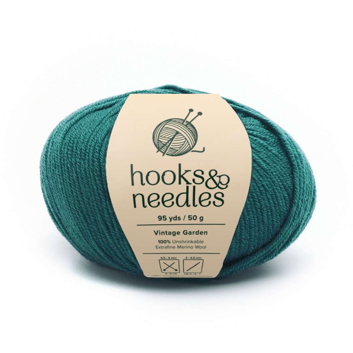 A teal yarn ball labeled "hooks & needles," 95 yds/50g, 100% extrafine merino wool—Vintage Garden series. It's unshrinkable, ideal for medium-weight projects, and includes care symbols on the wrapper.