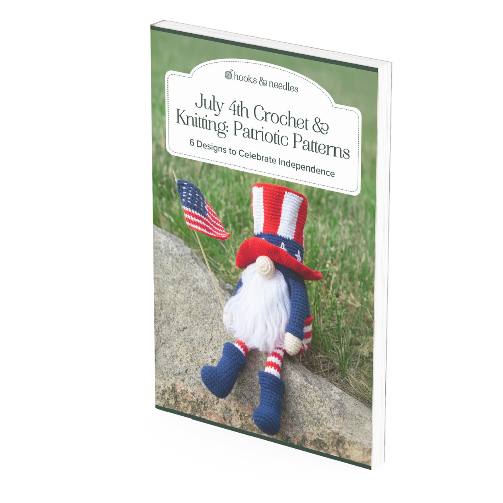 Book cover for "July 4th Crochet / Knitting Patterns," featuring a crocheted gnome in patriotic colors sitting on grass, holding an American flag.