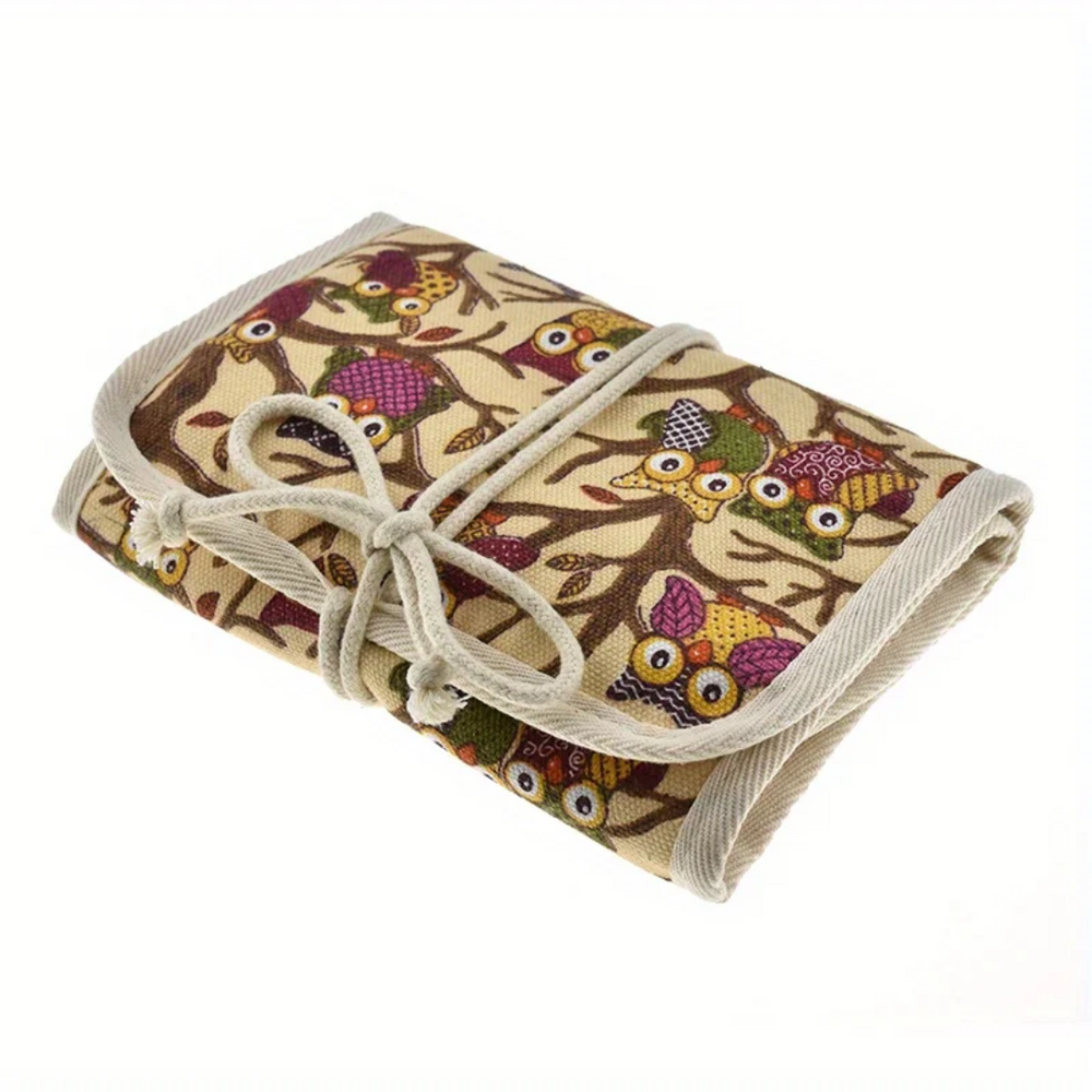 The Crochet Hooks Organizer is a rolled-up fabric case with a beige background adorned with colorful owl prints, tied with a cord for easy organization in style.