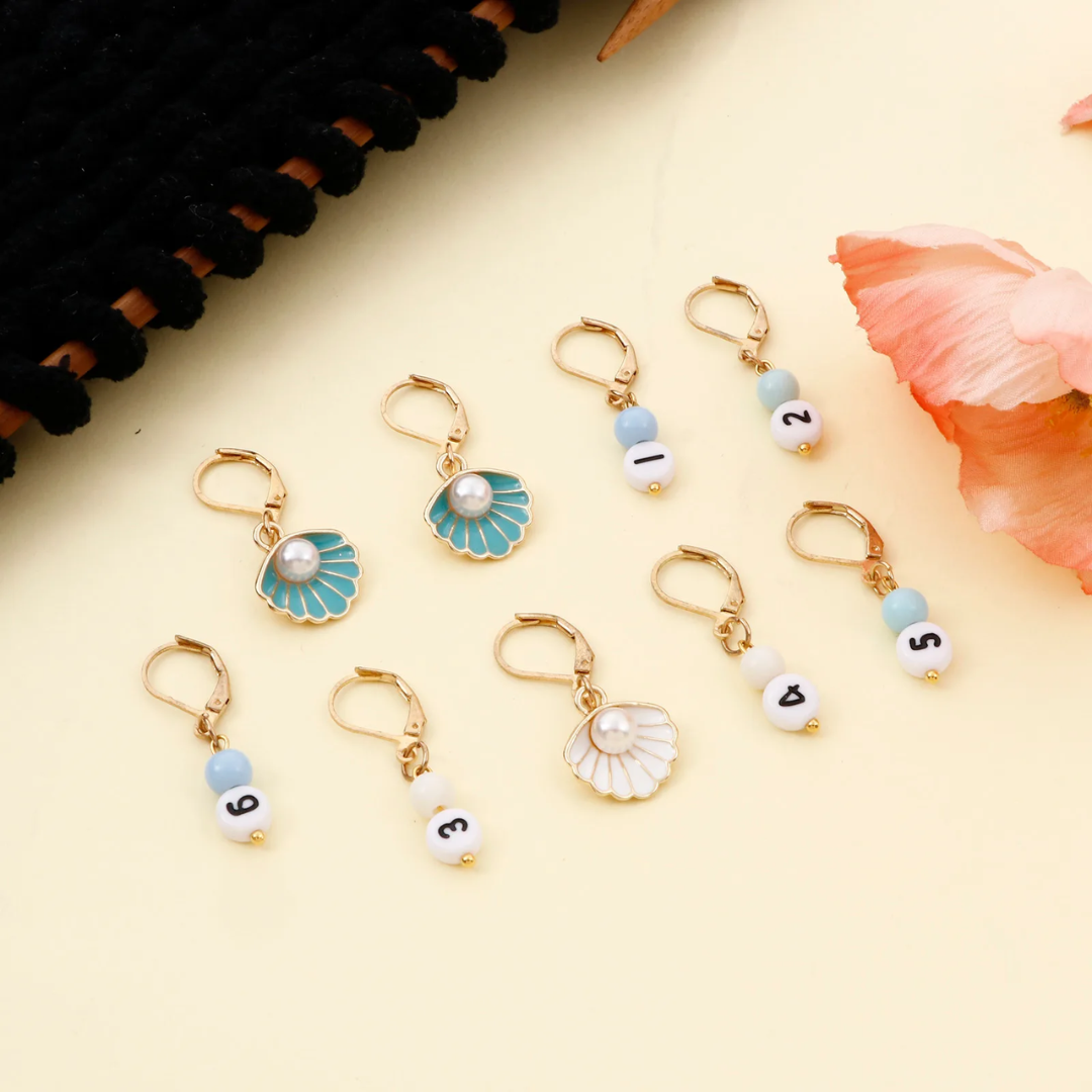 A collection of floral and numbered charm keychains, including Stitch Markers 9pcs, on a beige background.