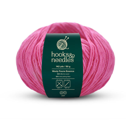 Discover the subtle allure of the Wooly Fauna Essence Yarn 50g with this pink ball of yarn, expertly crafted to combine 50% Merino wool with 50% anti-pilling fiber. At 142 yards and weighing 50g, it's perfect for light-weight projects on US knitting needles sizes 5-7 or crochet hook size US E-7, ensuring both durability and sophistication.