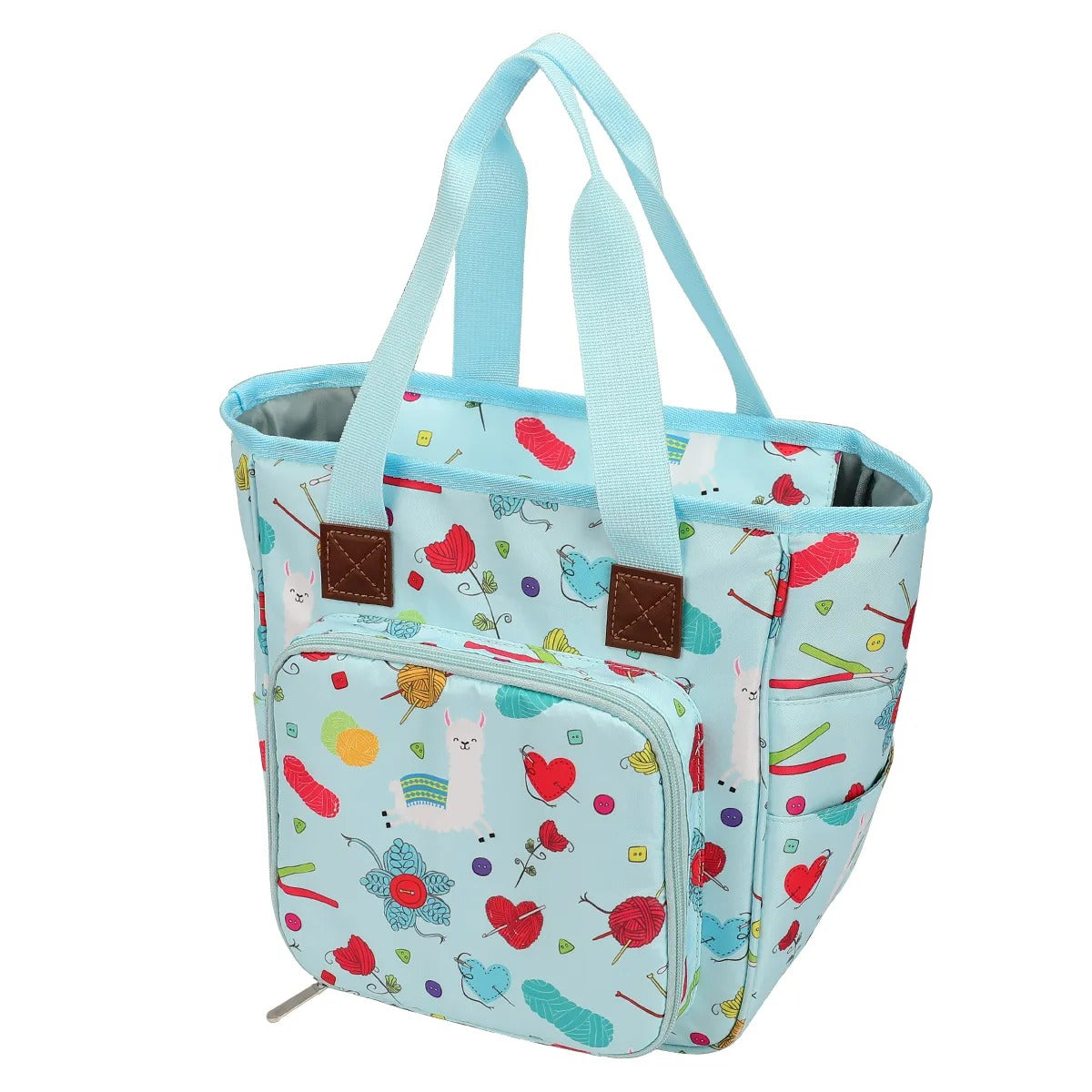 The Yarn Organizer Tote is a vibrant craft bag with teal handles, adorned with a playful pattern of cats, hearts, flowers, and assorted shapes on a light blue background. It's the perfect stylish solution for transporting your knitting or crocheting essentials.