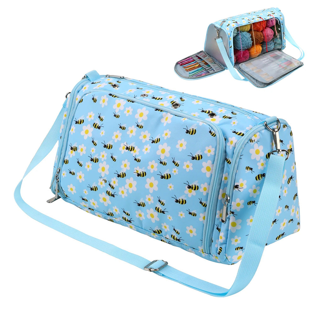 A light blue duffle bag with a floral and bee pattern, perfect for knitting and crocheting essentials. This spacious Yarn Bag - Storage Organizer features compartments for yarn and supplies, displayed closed and open. Plus, it's a waterproof storage bag to keep everything safe from spills.