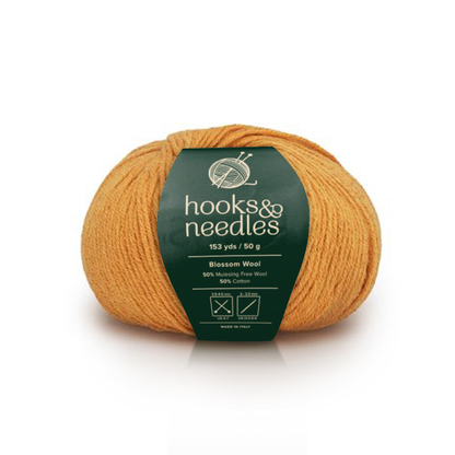 Image of Blossom Wool yarn, showcasing its soft texture and natural hues, ideal for creating cozy, elegant knitwear.