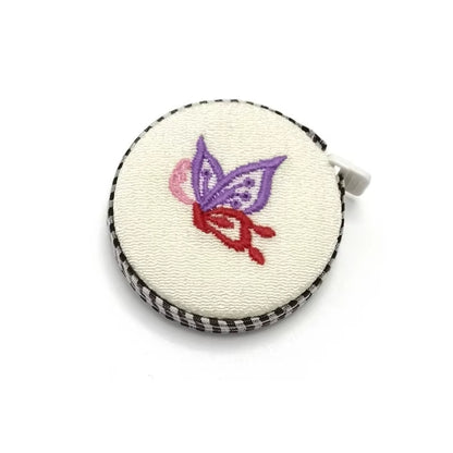 150cm Retractable Fabric Measuring Tape with a soft body, featuring an embroidered purple and red butterfly design—ideal for knitting and crocheting measurements.