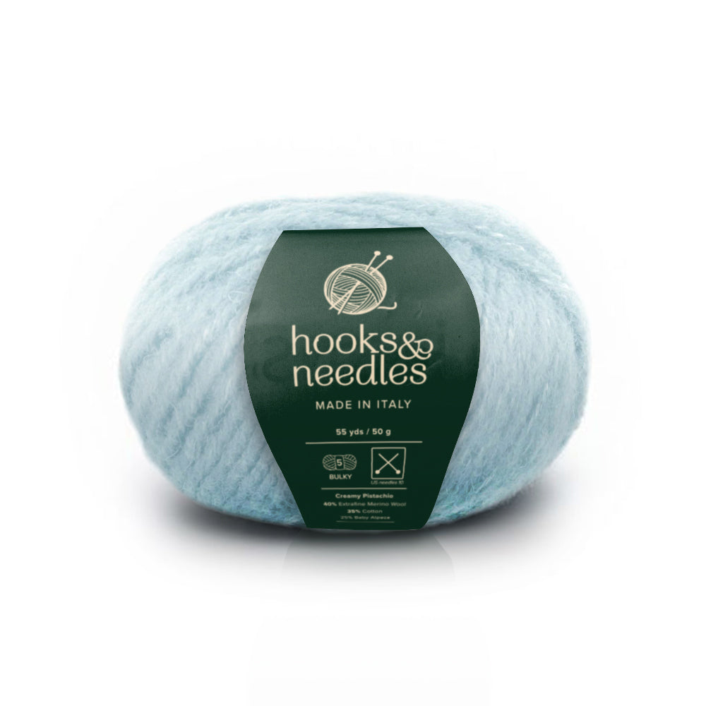 Image of Creamy Pistachio yarn, showcasing its soft texture and natural hues, ideal for creating cozy, elegant knitwear.