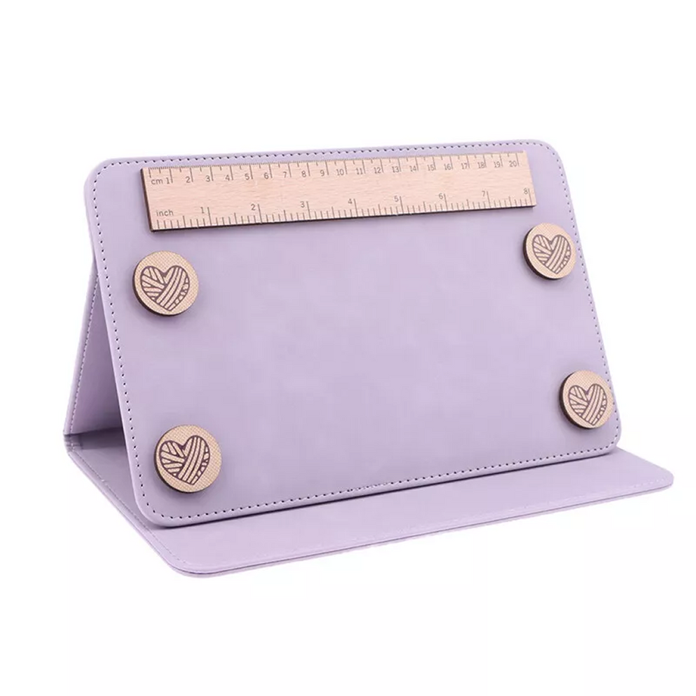 The Knitting/Crochet Chart Holder in lavender features a foldable design, four round wooden magnets, and a wooden ruler on top—ideal for keeping your knitting or crochet patterns secure and organized.
