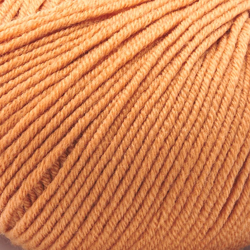 A close-up of Merino Charm Yarn 50g in peach shows the extrafine merino wool skein with neatly wound strands, highlighting its soft fiber texture.