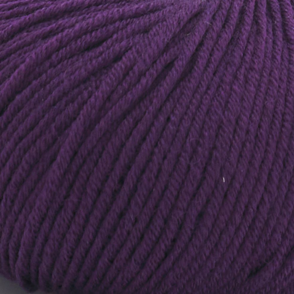 Close-up view of Merino Charm Yarn 50g in purple, showcasing the texture and individual strands of extrafine merino wool.