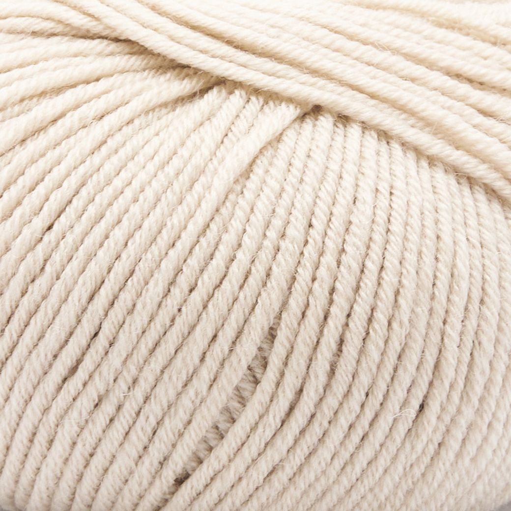 Close-up of Merino Charm Yarn 50g in a soft cream shade, showcasing its delicate texture and fine extrafine merino wool strands.