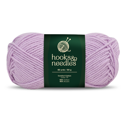 A 50g skein of Comfort Cotton, a light purple medium weight yarn, is 60% cotton and 40% acrylic, soft yet durable, and measures 83 yards.